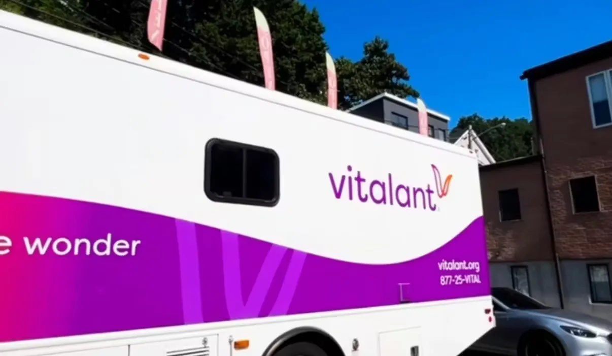 The purple Vitalant mobile donation bus parked at HudHaus for the community blood drive