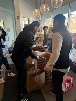 Volunteers organizing donated toys into collection bins at the Jog & Jingle event