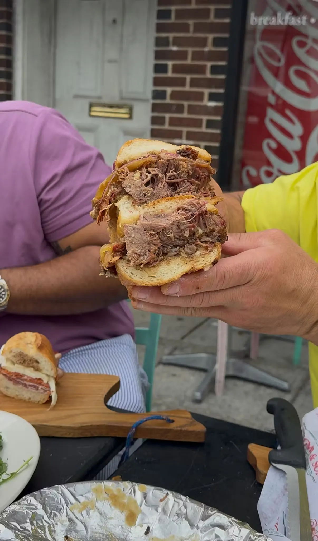 Close-up of a slow-cooked beef shortrib sandwich on house-made bread