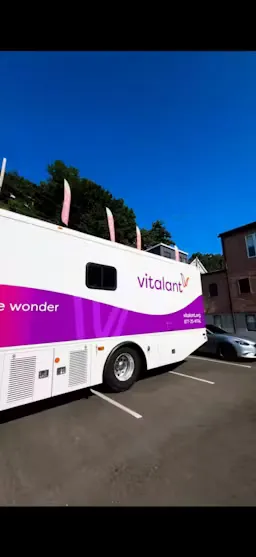 The Vitalant donation bus parked outside HudHaus during the community blood drive